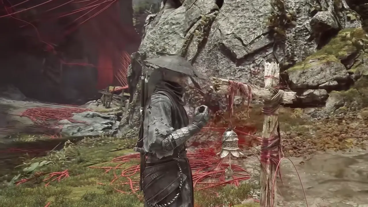Soul beside the bell post of Broken Puppet Valley, red threads across the grass
