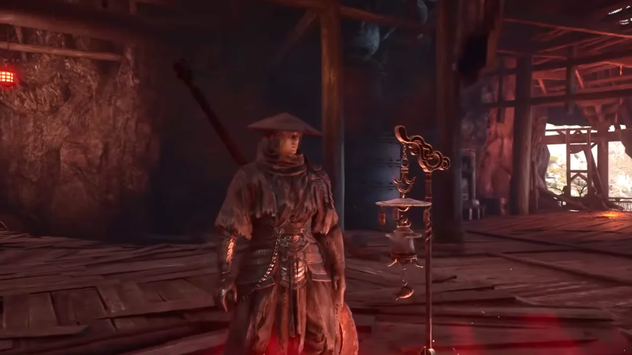 Soul beside the Valley Sha-Chi Tower Base bell, an ornate bronze bell post on the plank floor of the tower's dim red-lit base hall